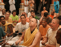 ISKCON devotees singing kirtan together in the temple hall