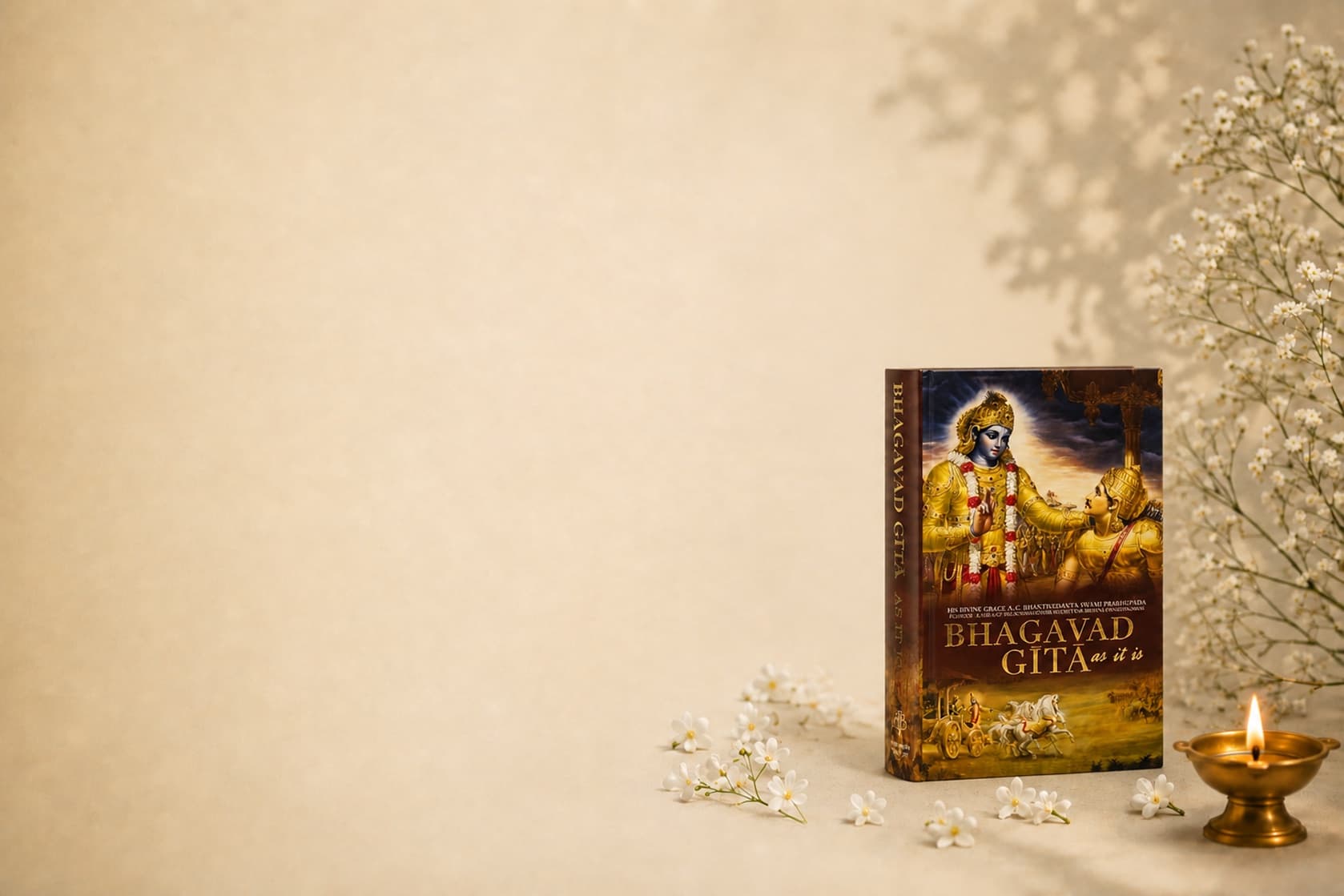 The Bhagavad Gita with a peacock feather and a lit brass diya
