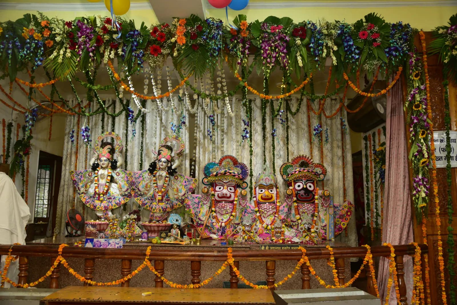 The Deities on the flower-decorated altar at ISKCON Kurukshetra