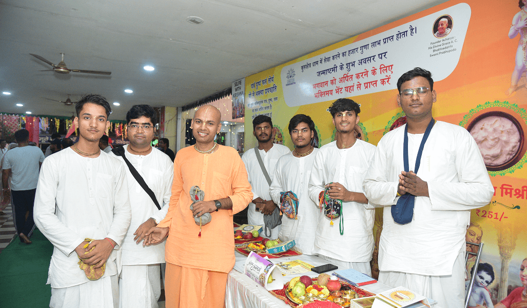 Devotees gathered with a sadhu at the temple seva stall