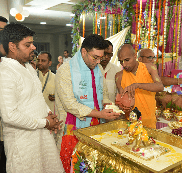 Devotees absorbed in kirtan at the temple