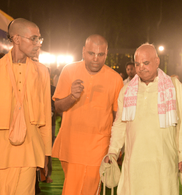 Sadhus in saffron robes together at an evening temple gathering