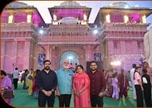 A family before the illuminated temple during a festival evening