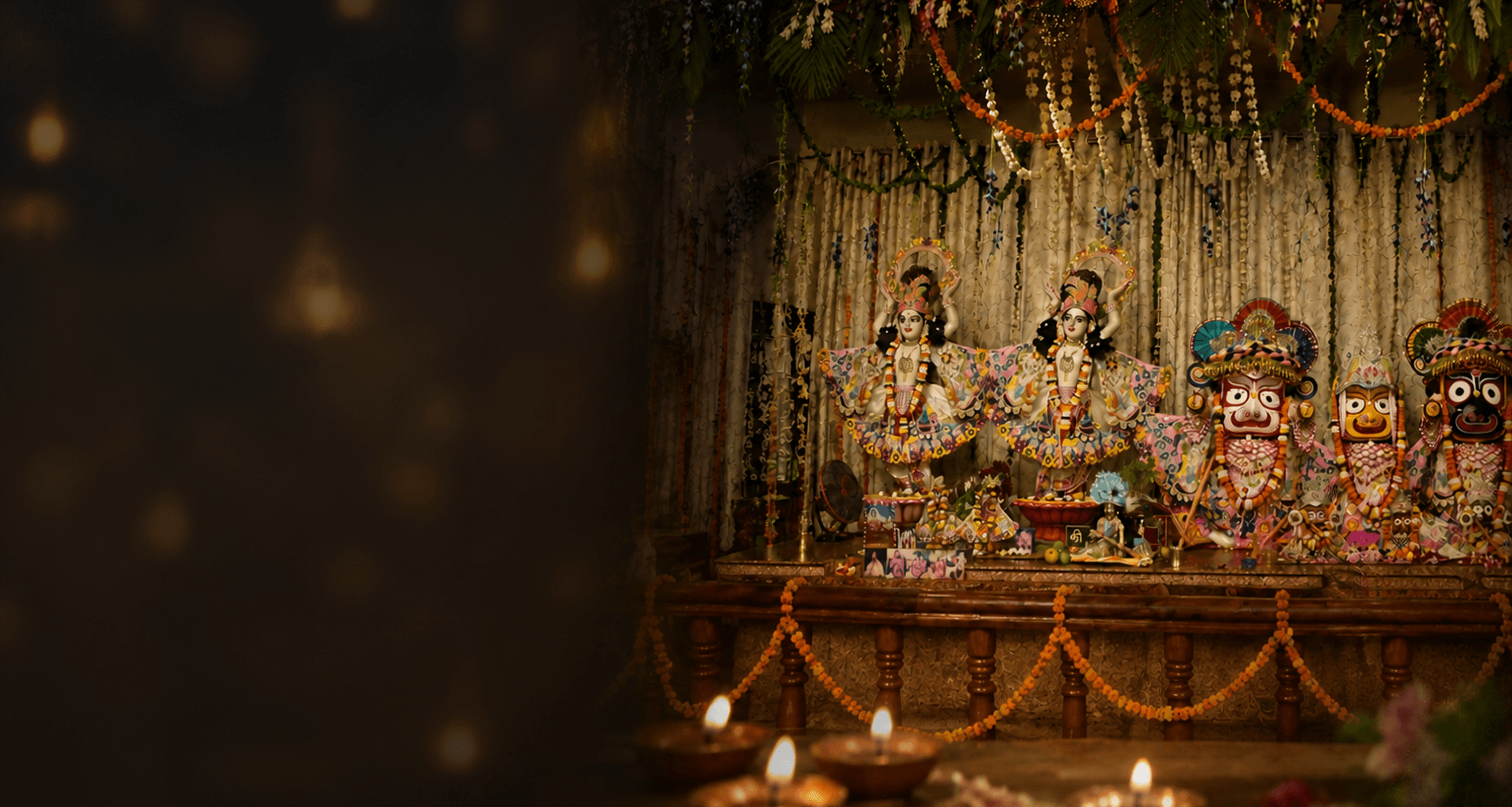 Deities of Gaura Nitai and Lord Jagannath on a garlanded altar with rows of lit diyas