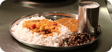 A simple prasadam thali with rice, sabzi and dal