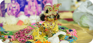 Laddu Gopal deity adorned with flowers