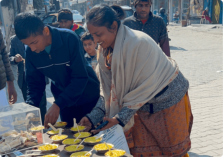 Devotees serving prasadam meals to passers-by on a Kurukshetra street