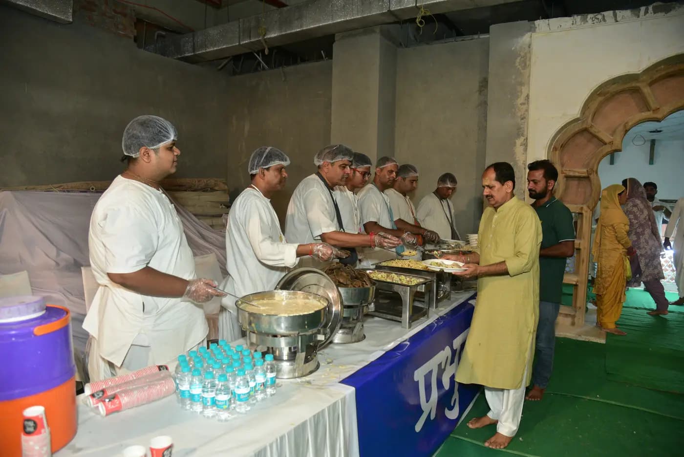Volunteers serving mahaprasadam to guests