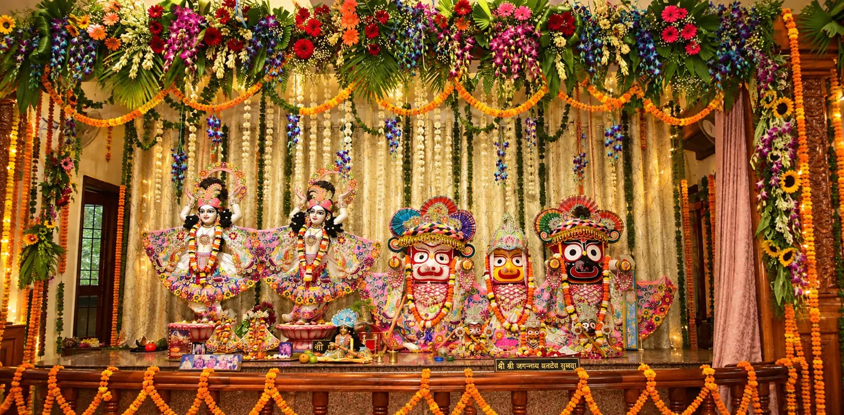 The Deities on the flower-decked altar at ISKCON Kurukshetra