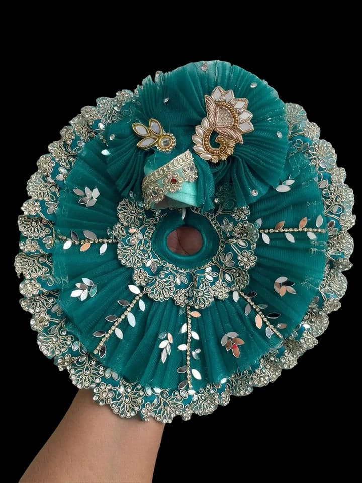 An embroidered teal poshak, a garment for the Deities